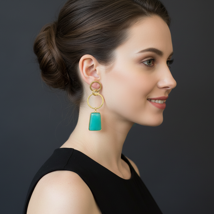 women wearing lumibella's Cyan Dangler Party Earrings.