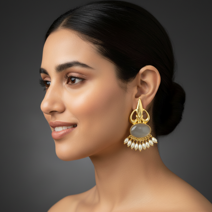 women wearing lumibella's Dangler gold earrings with grey stones. 