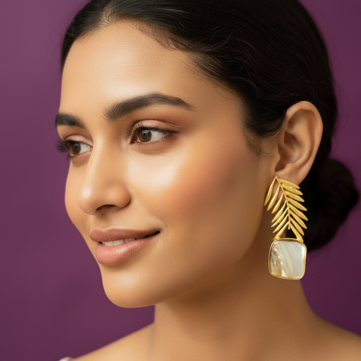 women wearing lumibella's Golden leaf modern earrings. 