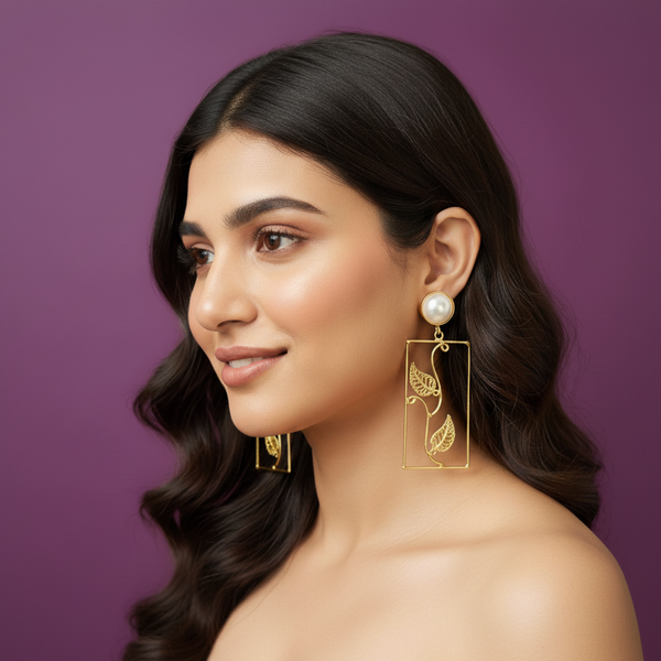 Woman wearing lumibella's Rectangle gold statement earrings. 