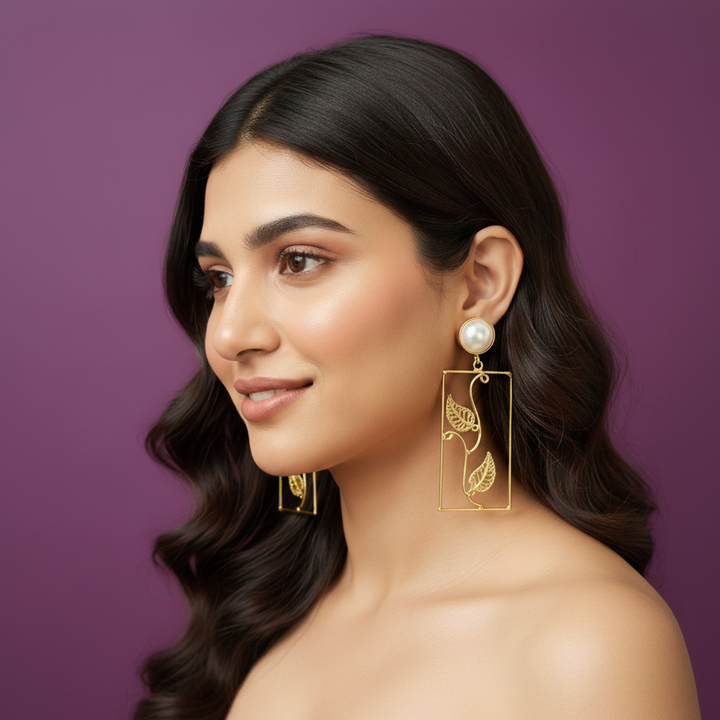 Woman wearing lumibella's Rectangle gold statement earrings. 