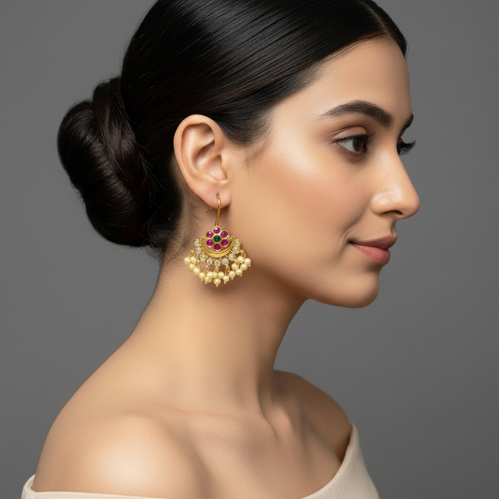 Woman wearing gold hook earrings  