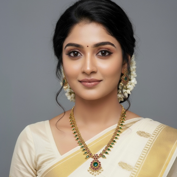 Woman wearing a traditional kerala saree with lumibella kerala jewelry  